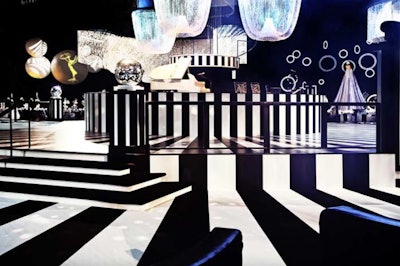 The 2011 Emmys Governors Ball had the theme of 'mod illusions' with a 1960s-style black-and-white decor scheme from Sequoia Productions that hearkened back to the era of Truman Capote's famous bash. Striped flooring made a big impact around the 60-foot-wide elevated circular dance floor, where a revolving orchestra platform served as the centerpiece. Striped chair covers continued the look throughout the ballroom. See more: '60s Mod Inspires Emmys' Graphic Black-and-White Governors Ball