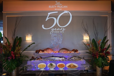 A 50th anniversary light projection sat above a celebratory ice sculpture that doubled as a cocktail hour raw bar decorated with local fish, oysters, shrimp cocktail, caviar, and various seafood salads.