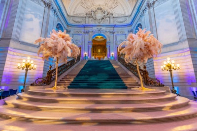 Bold, custom-fabricated pieces like giant ostrich feather trees adorned the hall's Charlotte Maillard Shultz staircase.