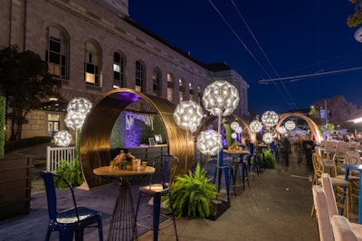 Meanwhile, concert-only ticket holders were welcomed back out on Grove Street, where the arrivals area had been flipped into an alfresco after-party. A variety of food and beverage stations were hosted by local restaurants, and playful performers from Gregangelo’s Velocity Circus—including woodland creatures and a stilt-walking fairy—greeted attendees and continued the theme.