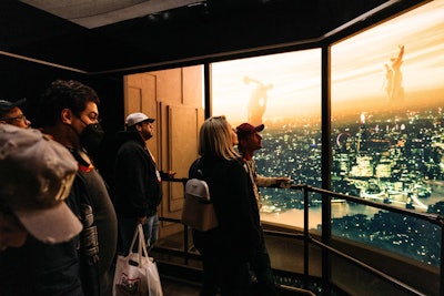 The final room simulated an elevator rising over a futuristic landscape.