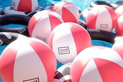 The pool was filled with branded beach balls and tubes for guests to enjoy.