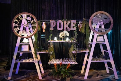 Mini poke bowls were arranged on an installation with swinging shelves, owls, and plants.