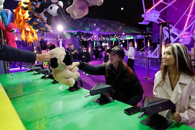 Fans were treated to rides on a Ferris wheel, funnel cake and corn dog bites, a photo booth, and custom airbrush trucker hats. Circus-like acts such as jugglers and stilt walkers performed throughout the event.