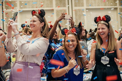 During a group photograph, guests were instructed to yell 'We're going to Disney World!' When they did, 10 confetti cannons exploded. 'The crowd went wild with excitement, and some were moved to tears,' remembered Grinnals. See more: See a Conference Inspired by Fairy Tales