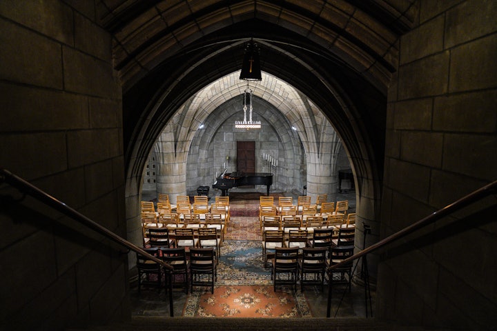 The Crypt Sessions are held in a chapel underneath the Church of the Intercession in Harlem, which features arched ceilings supported by massive columns.