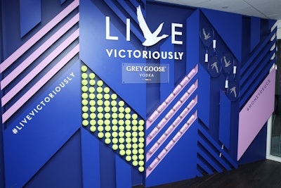 During the U.S. Open in 2019, the on-site Grey Goose Suite served guests cocktails and showed live matches for the duration of the tournament. Epsilon designed the suite, which included a colorful step-and-repeat that evoked wings, created with tennis balls, rackets, and purple cocktail glasses. See more: U.S. Open 2019: 22 Tennis-Theme Highlights From Sponsors and Satellite Events