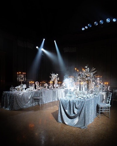 The set design featured a glitzy dinner party setting with sparkly floral arrangements and table linens.