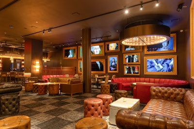 The lounge area is decorated with soft-distressed leather couches by Timothy Oulton and 12 NFT screens that come to life.