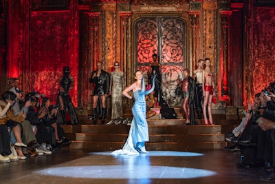 Julia Fox walked the runway wearing an ankle-length, form-fitting denim corset dress with pointy-toe matching denim boots. The two denim bull horns jutting from the bra were a standout embellishment.