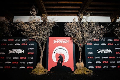 In 2018, to celebrate the first season of The Chilling Adventures of Sabrina, Netflix and MKG built an immersive, interactive house for the premiere party, then opened it to fans. The step-and-repeat area, where both cast members and fans had a chance to pose, used 3D silhouettes and trees to evoke imagery from the show. (After the premiere, images of the show's black cat Salem, posing dutifully for the cameras, were a big hit on social media.) See more: Netflix's Spooky 'Sabrina' Premiere Asks Guests to Choose Between Light and Dark