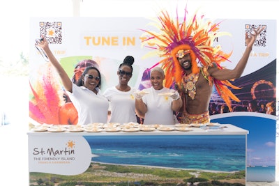 St. Martin Tourist Office hosted a bright and beachy booth inside the Grand Tasting Tent. Guests indulged in mini coconut sweet tarts from chef Gaelle Mussington, posed with model Mario Bazile, and entered to win a trip to the French Caribbean island via QR code.