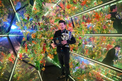 Setiawan posed with his winnings. This particular work inside his exhibit proved to be a standout photo moment for visitors.