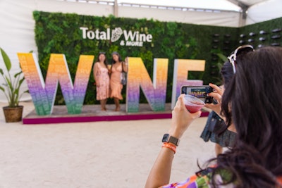 Total Wine & More’s corner booth tasting event featured “Wine” signage with a missing “i” so guests could stand in its place for photos.