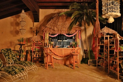 The estate’s atrium was transformed into a jazz club with live music from The Apollo Trio; other spaces included a cigar lounge and espresso martini lounge, a pizza parlor, and a hidden tiki bar speakeasy (pictured) with actual sand and cocktails served in coconuts.