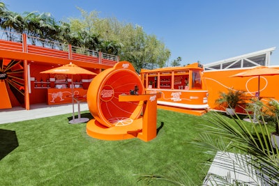 The activation included an Aperol-branded tram designed to resemble a modern Italian city streetcar, plus a kiosk where guests could play digital trivia games or create a custom AR experience. There was also an oversized, interactive video dome from Classic Photo Booths that had a slow-motion camera, plus a sunbeam installation made from a glowing orange mirror and neon LED lighting.
