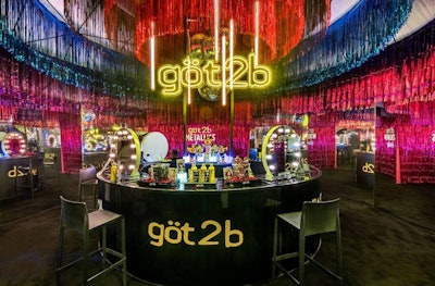 Another fun use of color came from göt2b's YOU Style Station at NYLON House. On site, guests could get hairstyles done with göt2b's metallic-colored hair extensions—which were also evoked in the space's decor, which included vibrant metallic streamers, floor-to-ceiling mirrored walls, and neon lights.