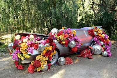 Other installations included a silver-painted car covered in flowers and disco balls. At the end of the experience was an area with a disco-inspired roller-skating rink; a colorful dance floor; retro arcade games; food trucks; and other fun, interactive details. The event was a collaboration between Los Angeles-based experience studio Constellation Immersive (an affiliate of Creative Artists Agency) and Grammy Award-winning musician Nile Rodgers, who curated the soundtrack as DiscOasis’ official “groovemaster.” See more: Get Inspired By This Music-Driven, Interactive Theatrical Walk-Through