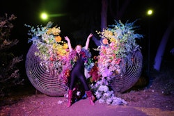 Is it any surprise that something called DiscOasis offered a wealth of fun event inspo? After all, the walkthrough theatrical experience was billed as a “glittering sonic fantasia for the soul.' Taking over South Coast Botanic Garden near Los Angeles in 2021, the public ticketed experience let guests explore six different areas, each featuring a different photo op-friendly art installation that was inspired by a specific disco song, as well as a live actor interacting with guests. In one fun spot, a giant disco ball was split open and filled with lush florals.