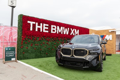 BMW returned to the Derby to show off its BMW XM luxury sports activity vehicle. A rose-decorated wall behind the car was created by Louisville-based Susan's Florist.