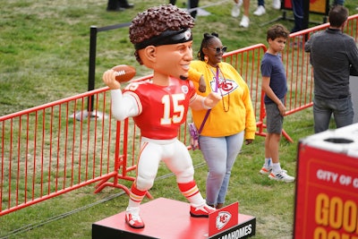 A fan posed with a life-sized bobblehead of Chiefs quarterback Patrick Mahomes.