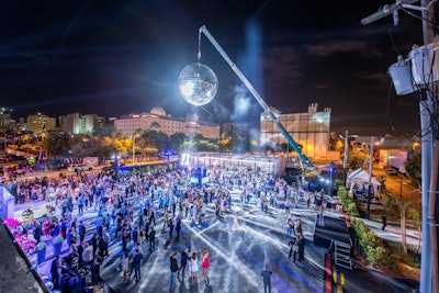 Sure, you could take a standard approach and have a disco ball hanging above a dance floor. Or you could opt for what was billed as the largest disco ball in the country, a 20-foot piece from Salt Lake City-based artist Derek Dyer. That’s the route mega-real estate development Paramount Miami Worldcenter took for its glitzy launch event in 2015, which was designed and produced by Triton Productions. The enormous disco ball—which consisted of more than 1,000 mirrors and weighed 2,500 pounds—was raised 47 feet in the air. The stunt created the desired effect: The first 500 people who showed up to the event weren’t on the invite list, according to the event team. Overall, the eye-catching gathering drew 1,500 people, as well as numerous gawkers from neighboring residences who watched from their balconies as light from the disco ball bounced off their buildings. See more: See How the Country's Largest Disco Ball Became an Event Centerpiece