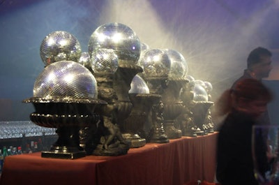 Finally, here’s a fun throwback to 2009, when the Central Park Conservancy hosted its Halloween Ball fundraiser. The kitschy affair eschewed formal floral arrangements and fancy furniture for spooky props and atmospheric lighting. Sitting atop the main bar in heavy urns, disco balls of different shapes reflected hundreds of dots of light onto the ceiling of the cocktail space, essentially creating a starry pattern. As an ominous touch, video graphics of lightning bolts flashed across this surface, and a fog machine shrouded the room in a hazy mist. Frank Alexander NYC handled the design. See more: Central Park Conservancy Casts Halloween Ball in Eerie Light