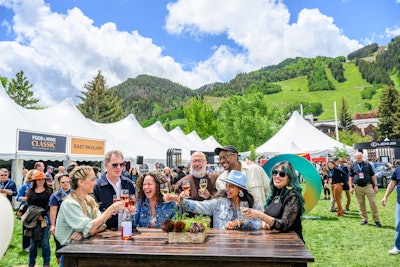 Andrew Zimmern, Brooke Williamson, Stephanie Izard, Bobby Flay, Maneet Chauhan, and Claudette Zepeda posed and toasted by the “40” sculpture stationed in the courtyard of the Grand Tasting.