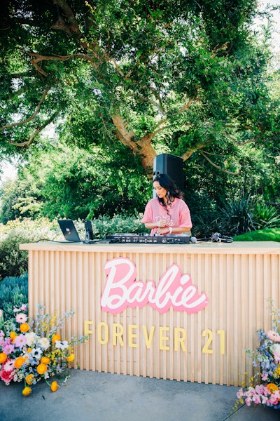 A DJ, in a Barbie-labeled booth, kept guests on their feet.