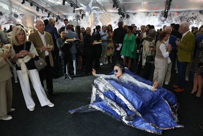 Throughout the evening, multidisciplinary artist Irene Hsiao performed 'Blue Alice.' The performance piece saw her languidly dancing through cocktail hour in a rustling, silvery gown.