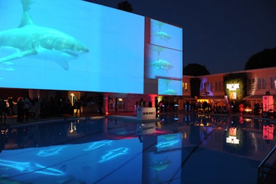 To mark the 25th anniversary of Shark Week, Discovery hosted an event in 2012 that put sharks in the pool of The Beverly Hilton. The scary fish weren't real, of course, but rather slowly moving projections devised by the planning and production team from Event Eleven. See more: Sharks Infest Beverly Hilton Pool at Discovery's Shark Week Anniversary