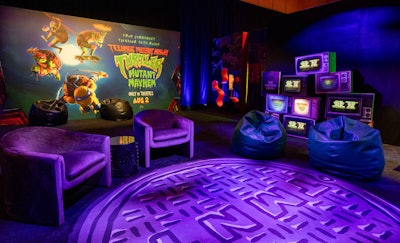 Guests then made their way through a second portal, which transported them to a Teenage Mutant Ninja Turtles lounge designed to celebrate the brand and the new movie opening in August. Custom elements included a '90s-style stack of old TVs playing the new film's trailer, a festival-style fence wall featuring exclusive TMNT merch, a stop-motion photo booth, a TMNT arcade, a custom oversize manhole-cover carpet, a live DJ, and daily happy hours.