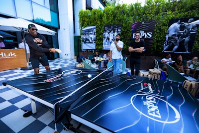 Former 49ers wide receiver Terrell Owens is seen playing a round of pingpong at the athlete lounge.