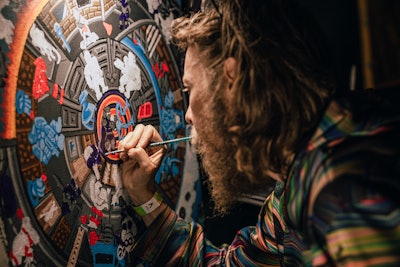 Various artists were commissioned to paint live at the event, and some finished their works at the Colorado Convention Center on Friday.