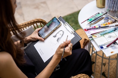 An artist was on site to create real-time sketches of attendees.