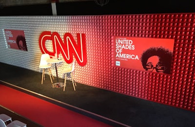 CNN's SXSW house had an apple theme in 2018. The front of the building was covered in vines and apples, and the stage backdrop featured apples painted in an ombré design. The fruit also served as centerpieces. CNN worked with Advoc8 and Pink Sparrow to produce the event.