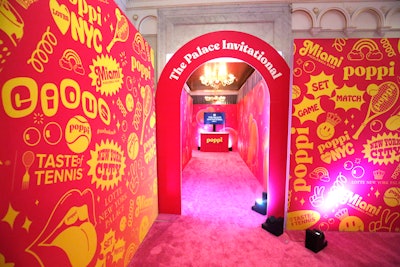Guests were welcomed onto the pink carpet (literally) through a pop art-style archway created by New York-based boutique brand storytelling agency Kennett Creative. Aside from nods to Poppi alongside graphic wallpaper, strawberry lemon and orange flavors of the bubbly canned drink were up for sampling as they were incorporated into the Courtside Cosmo and other on-theme cocktails.