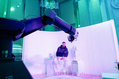 There were also several interactive video booths designed for content sharing. One was a robotic “Glambot” arm (pictured) that gave guests a chance to model their headphones as they stepped into the product photography key art to be featured in their own Bose ad. The other was a karaoke experience inside a Porsche; guests could sit in the vehicle, grab the mic, and sing along to the headliners’ tracks—highlighting Bose’s audio integration with Porsche and creating another fun, shareable moment.