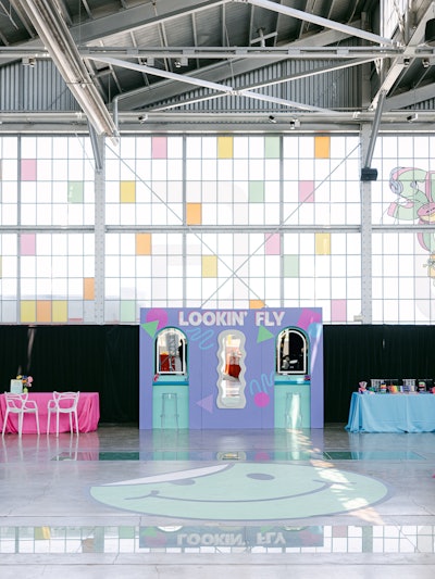 The venue's windows became an important element of the event's look, so colorful decals were added to some of the glass panes. Event fabricator Modest Peach created this glam station with three mirrors that allowed guests to add some '90s flair (hello, butterfly clips) to their look.