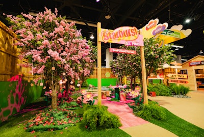 At last year's VidCon in Anaheim, Calif., Mars celebrated its candy brands—including M&M’s, Snickers, Twix, Orbit, Extra, 5 Gum, Skittles, and Starburst—with a large, summer camp-inspired booth called Camp Sweet Springs. Each brand had its own separate activation within the space. At Starburst’s pretty-in-pink “feel-good forest,” guests were invited to write encouraging, positivity-focused messages for each other, which were then hung from the trees with wooden clips. The activation was designed and executed by the experiences team at Condé Nast, with fabrication and build by 15/40 Productions. See more: VidCon 2022: 35 Clever Ideas for Trade Show Booths and Brand Activations From the Convention's Big Return