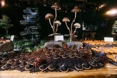 The camouflaged table featured savory and sweet bites, including these truffles, and earthy decor like mushrooms and greenery.