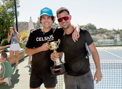 The winners of the pickleball tournament: event host David Dobrik and actor Taylor Lautner.