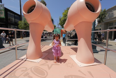 Other on-theme highlights included larger-than-life blow-dryers (pictured), a bouncy bus, wacky mirrors, and foam scrubbers. After passing through the fun house, kids strutted their back-to-school looks on a runway.