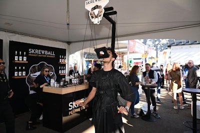 A festivalgoer took a shot of Skrewball peanut butter whiskey using a unique contraption during Southern Glazer's Wine & Spirits Trade Day.