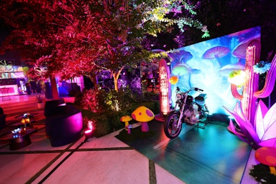 An interactive motorbike photo op let guests drive through a whimsical field of illuminated mushrooms.