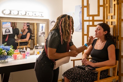 Glenroy’s makeup station featured an array of Rare Beauty products, a line by Selena Gomez, who plays Mabel Mora in the series. A makeup artist was on hand to give attendees a touch-up before heading to an onstage photo op. The backstage area also featured dressing rooms and the hallowed theater’s infamous signature wall, which eventgoers could sign.