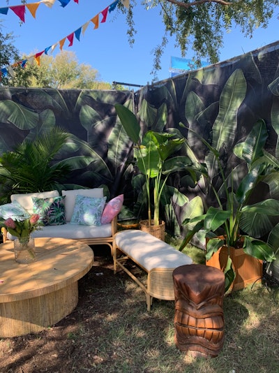 Another new experience at ACL this year was the Barton Beach Club Tiki Bar, produced by C3 Presents. The separate area was decked out in tropical decor such as wicker furniture, tall green plants, florals, surfboards, and fake parrots.