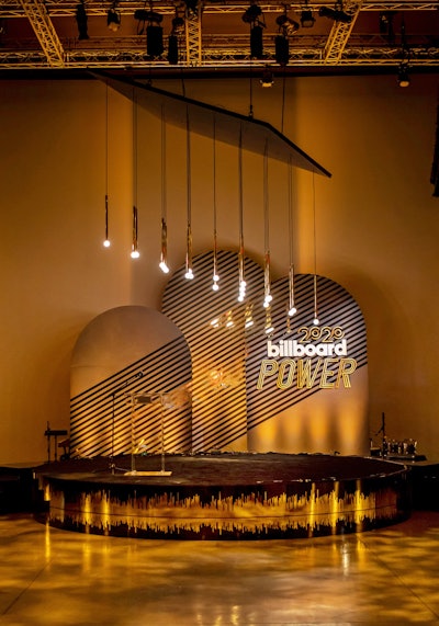 During Grammys week in 2020, Billboard celebrated its annual Power 100 list, which honors the music industry’s top executives, at NeueHouse in Los Angeles. The event had a small stage that made a big impact with hanging lightbulbs and a striking gold design. Shiraz Creative handled event design and production, while Stoelt Productions handled fabrication, rigging, and permitting. See more: Grammys 2020: What You Missed at the Week's Coolest Parties