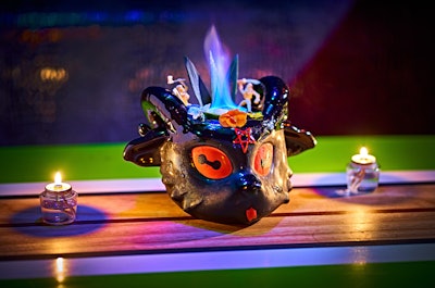 The self-described “hellscape” bar serves rum-based, tiki-inspired drinks including the 'Chaos Magick,' a nod to the classic tiki drink Black Magic, with rum fire, green chartreuse, coffee liqueur, cold brew concentrate, ras el hanout syrup, and alpine bitters; the 'Cobra's Fang' with a blend of rums, Fassionola syrup, lime, orange, and absinthe; and the 'Archfiend' with jalapeño-infused tequila, makrut leaf-infused mezcal, galangal agave syrup, lime cordial, hibiscus syrup, and hellfire bitters.