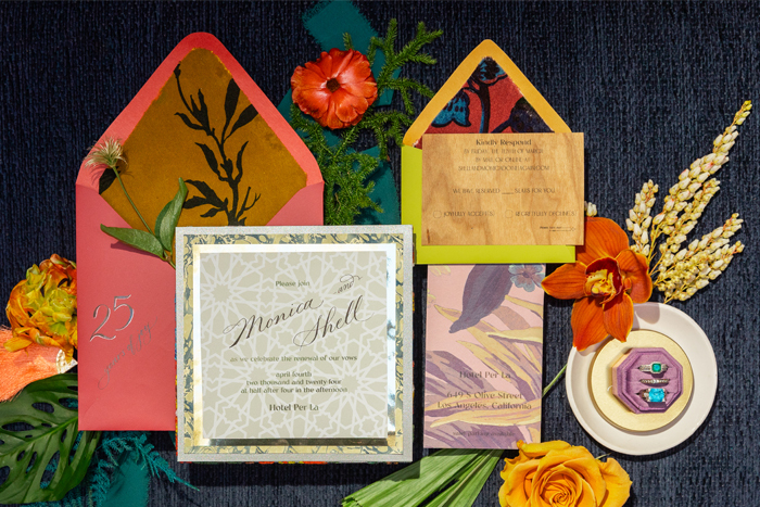 An invitation featuring velvet, leather, wood, and hand-marbled textures.